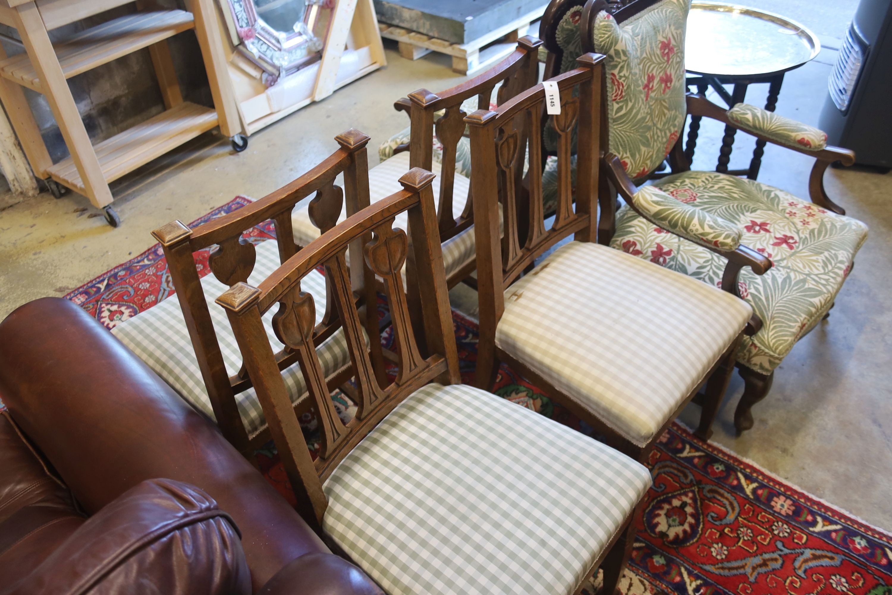 A set of four Art Nouveau carved oak dining chairs